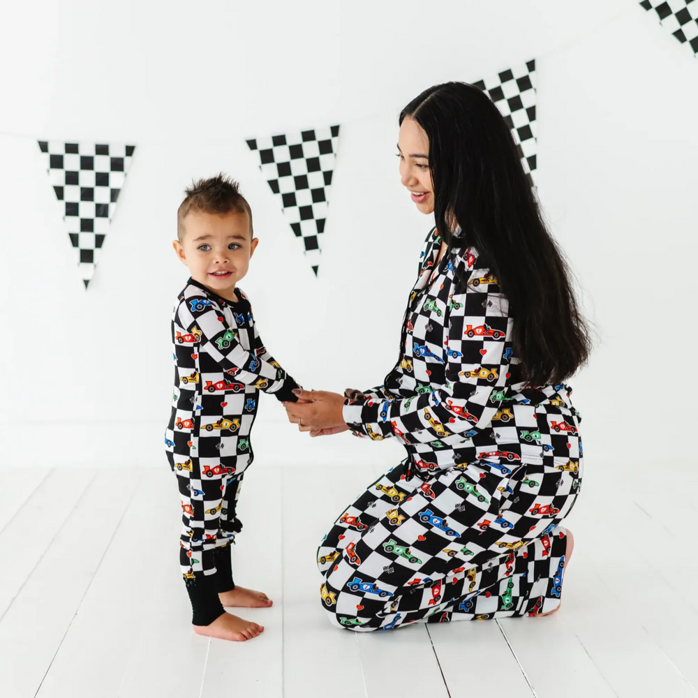 
                      
                        Kid in Racecar checkered footies by Kiki and Lulu
                      
                    