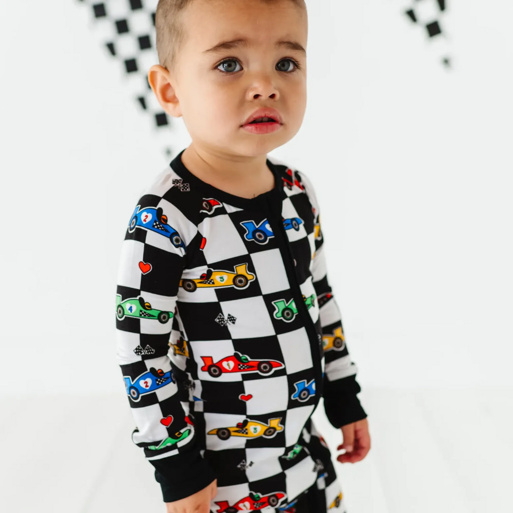 
                      
                        Kid in Racecar checkered footies by Kiki and Lulu
                      
                    