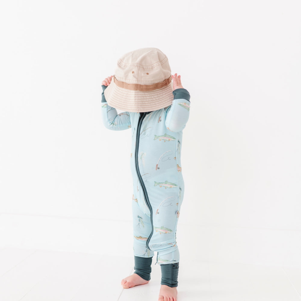 
                      
                        Child wearing a light blue onesie with a pattern, standing on a white background
                      
                    