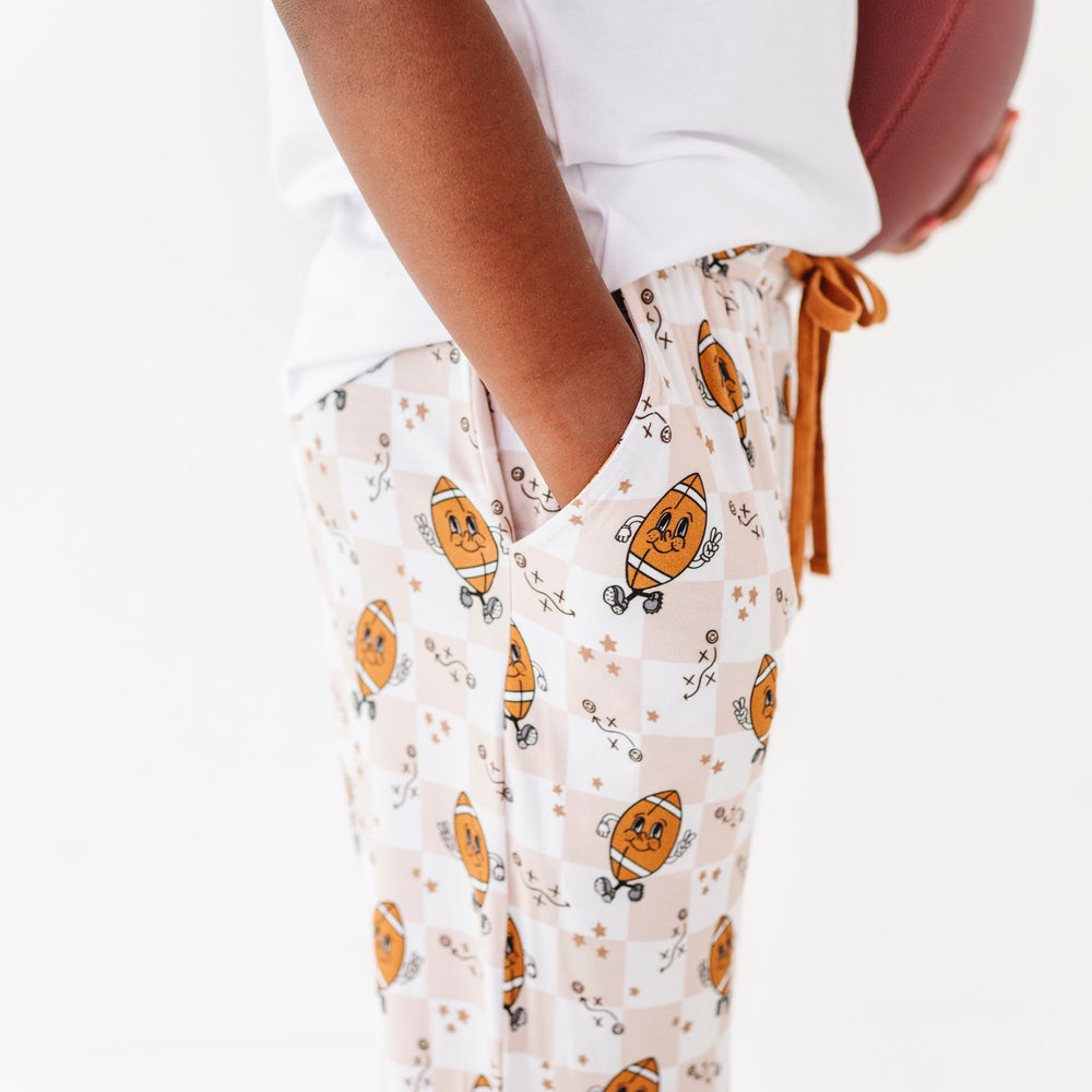 
                      
                        Person wearing white pajama top and pumpkin-patterned pants on a white background
                      
                    