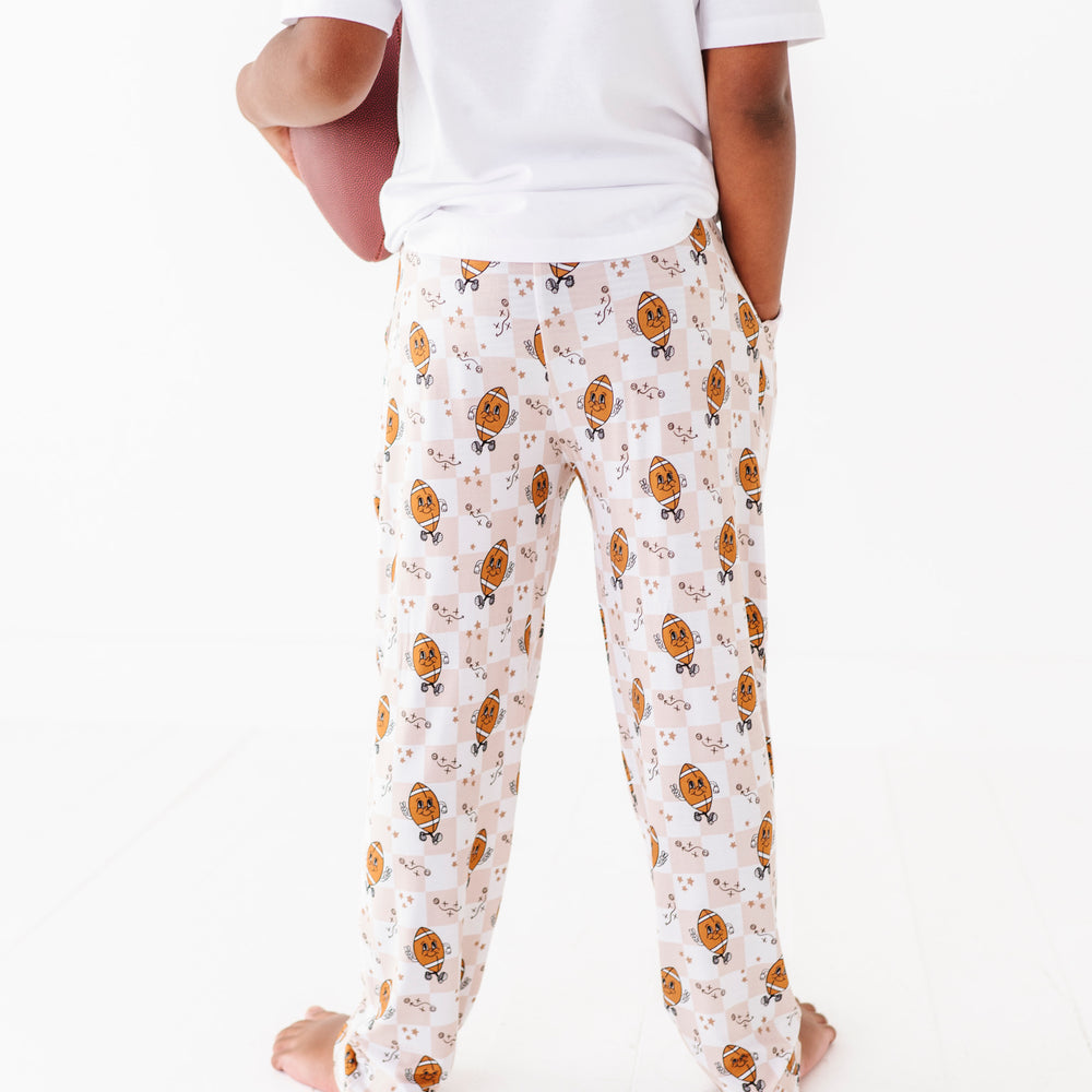 
                      
                        Person wearing a white t-shirt and patterned pajama pants on a white background
                      
                    