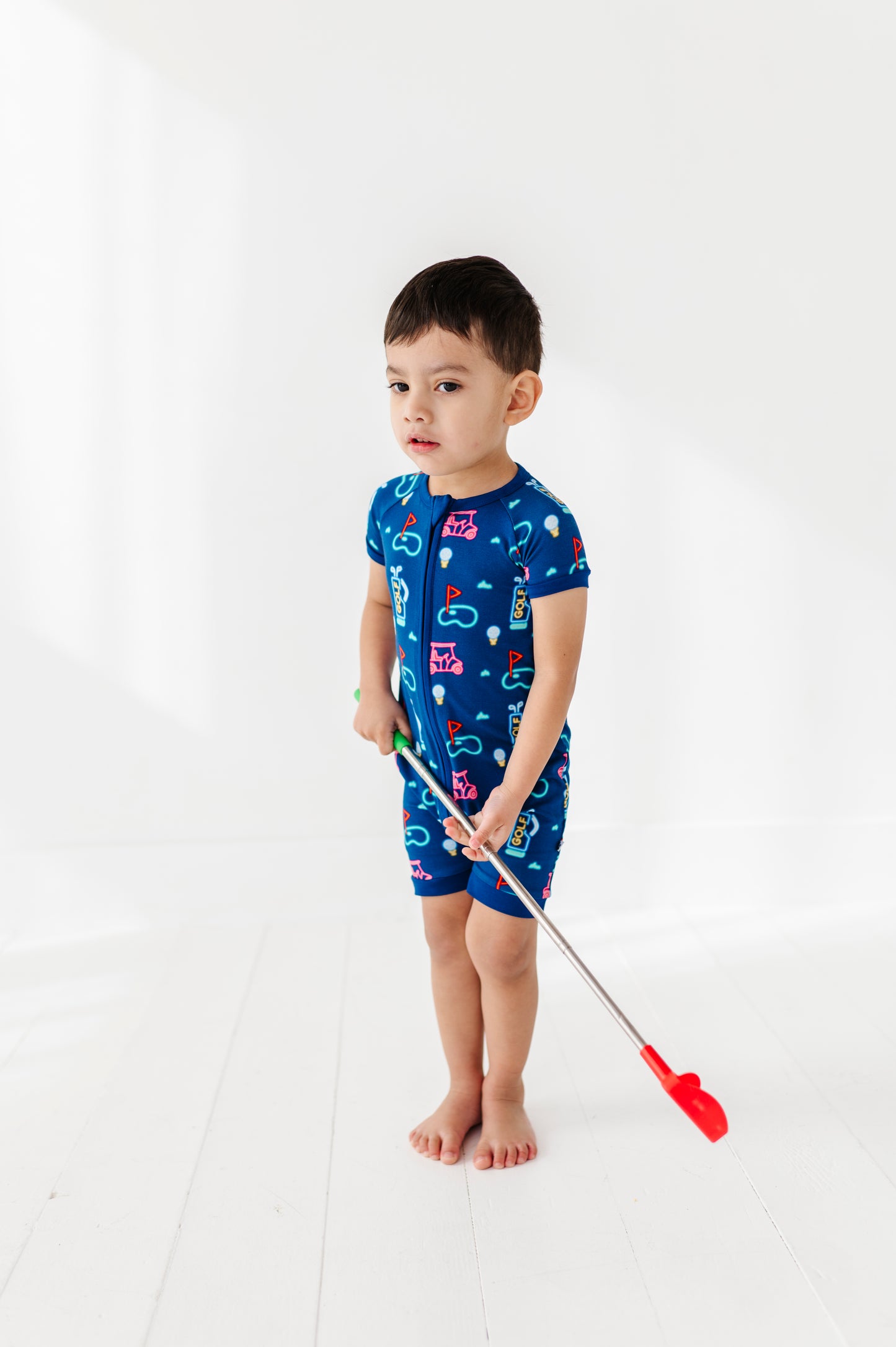 Boy Wearing Neon Golf Shorties by Kiki and Lulu