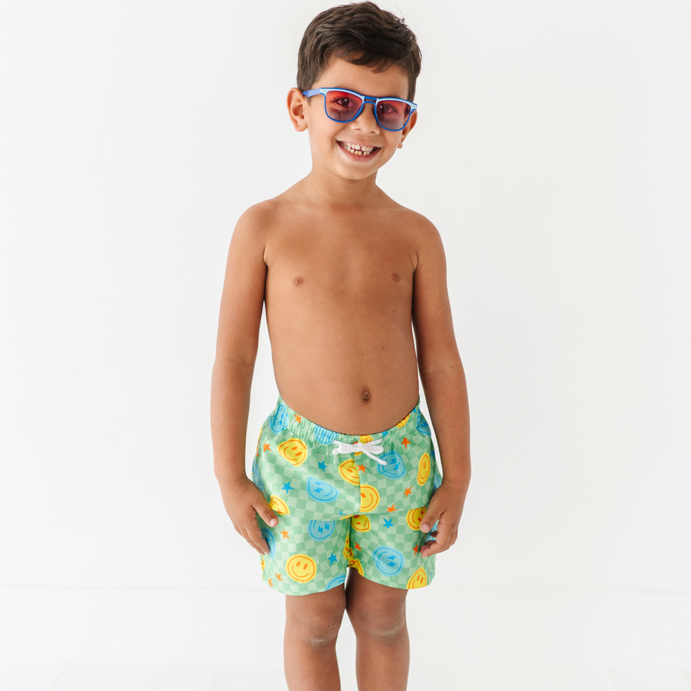 Boy in Neon Smiley Swim Trunks