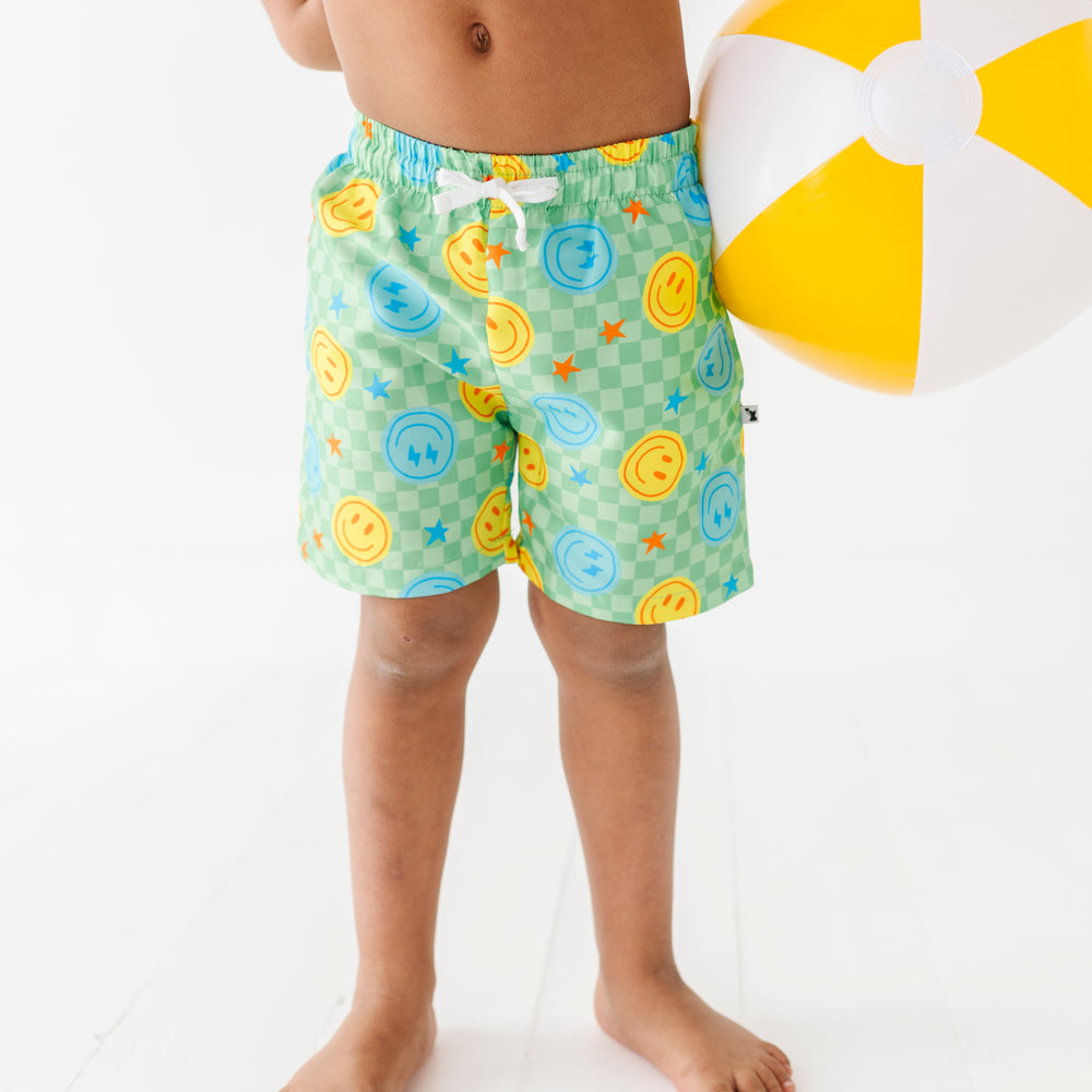 
                      
                        Boy in Neon Smiley Swim Trunks
                      
                    