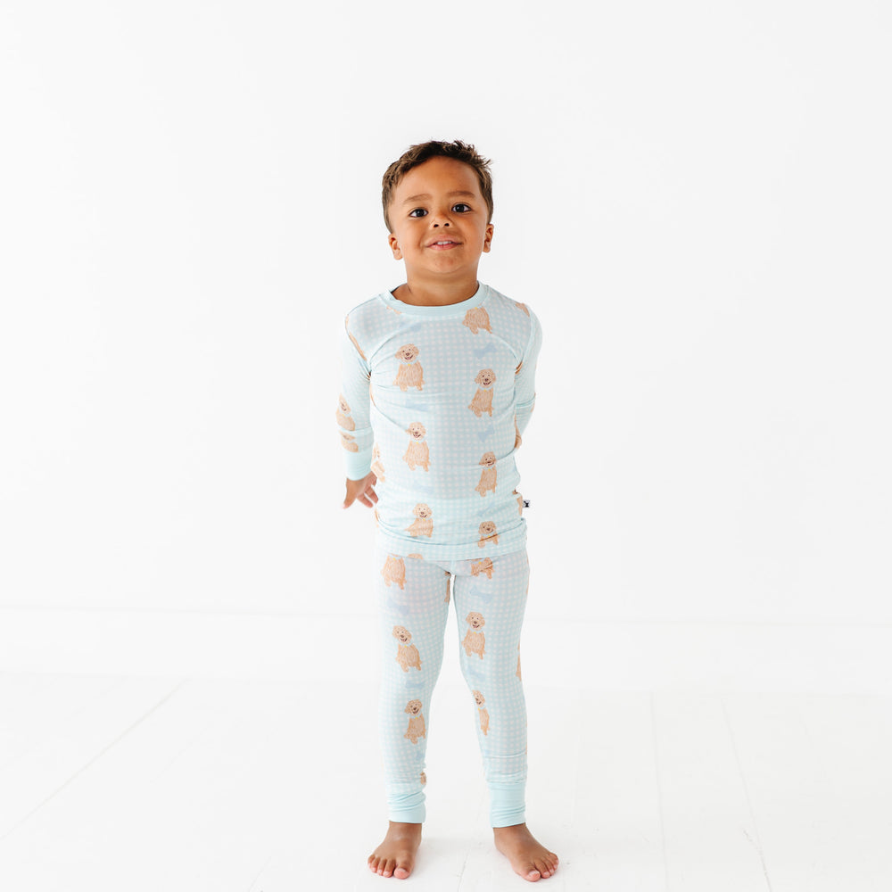 
                      
                        Child wearing a light blue pajama set with bear pattern on a white background
                      
                    