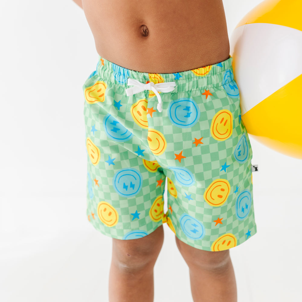 
                      
                        Boy rocking Neon Smiley Swim Trunks 
                      
                    
