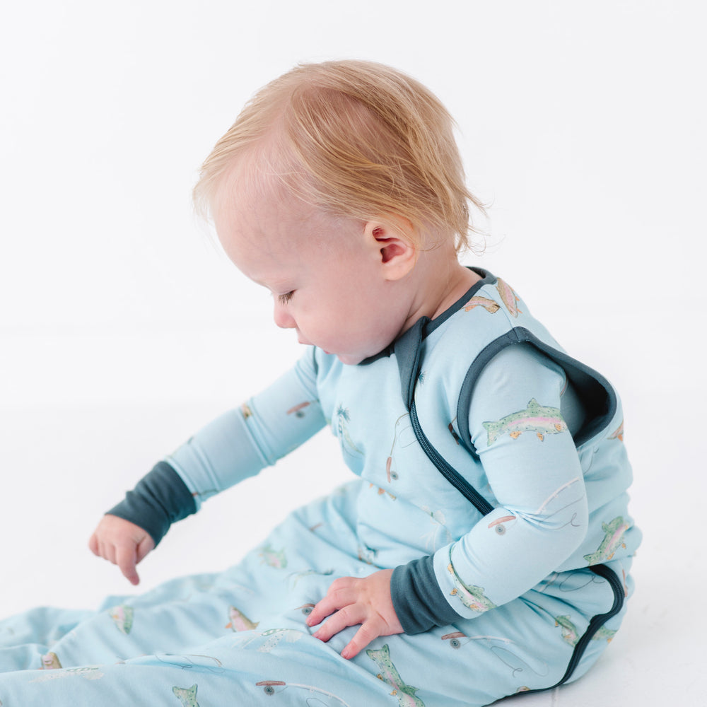 
                      
                        Baby in a blue sleep bag with animal pattern on a white background
                      
                    
