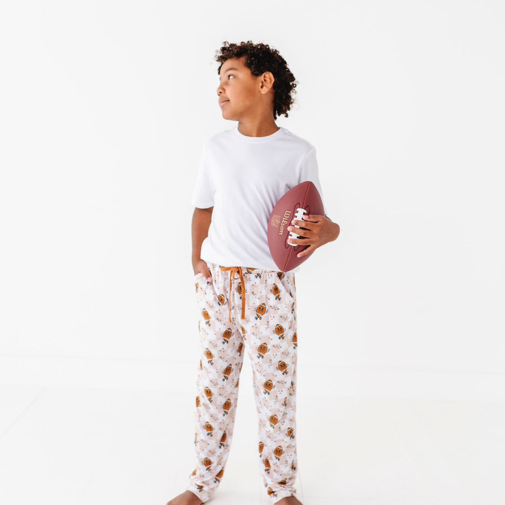 
                      
                        Person wearing a white t-shirt and patterned pajama pants on a white background
                      
                    