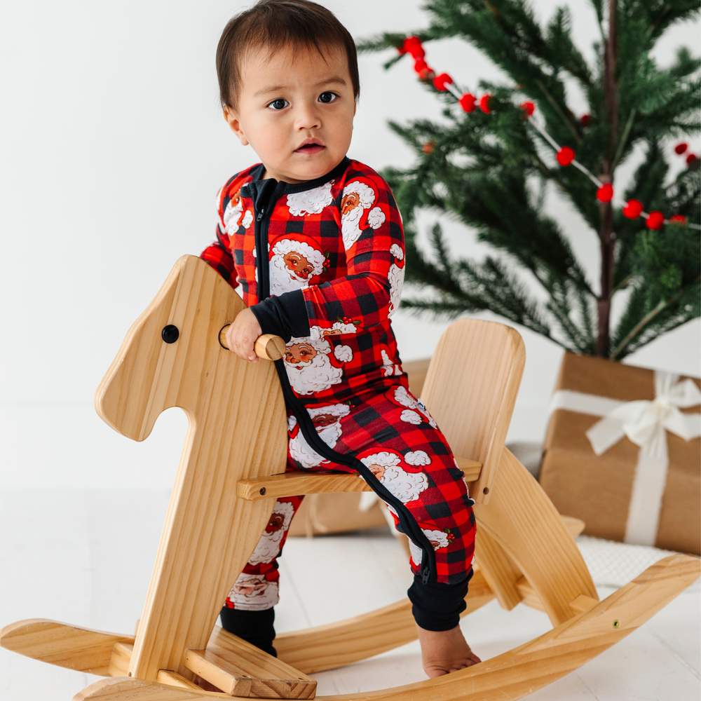 Baby in buffalo check santa pajamas by Kiki and Lulu