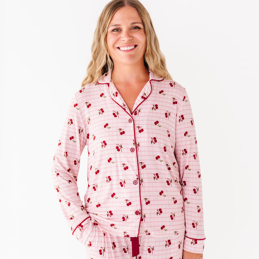 
                      
                        Woman wearing a pink and red patterned pajama set on a white background
                      
                    