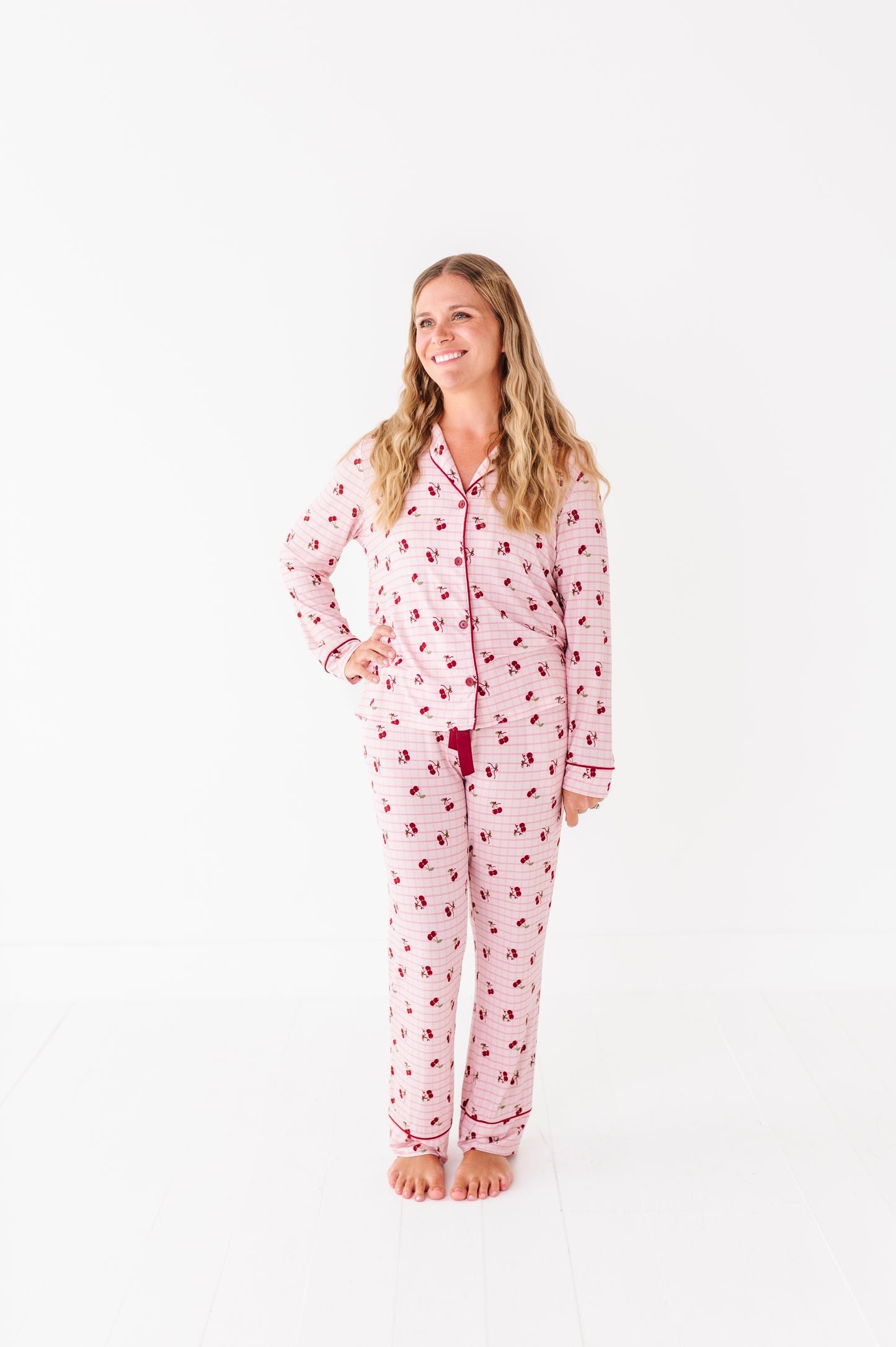 Woman wearing a pink pajama set with a white background