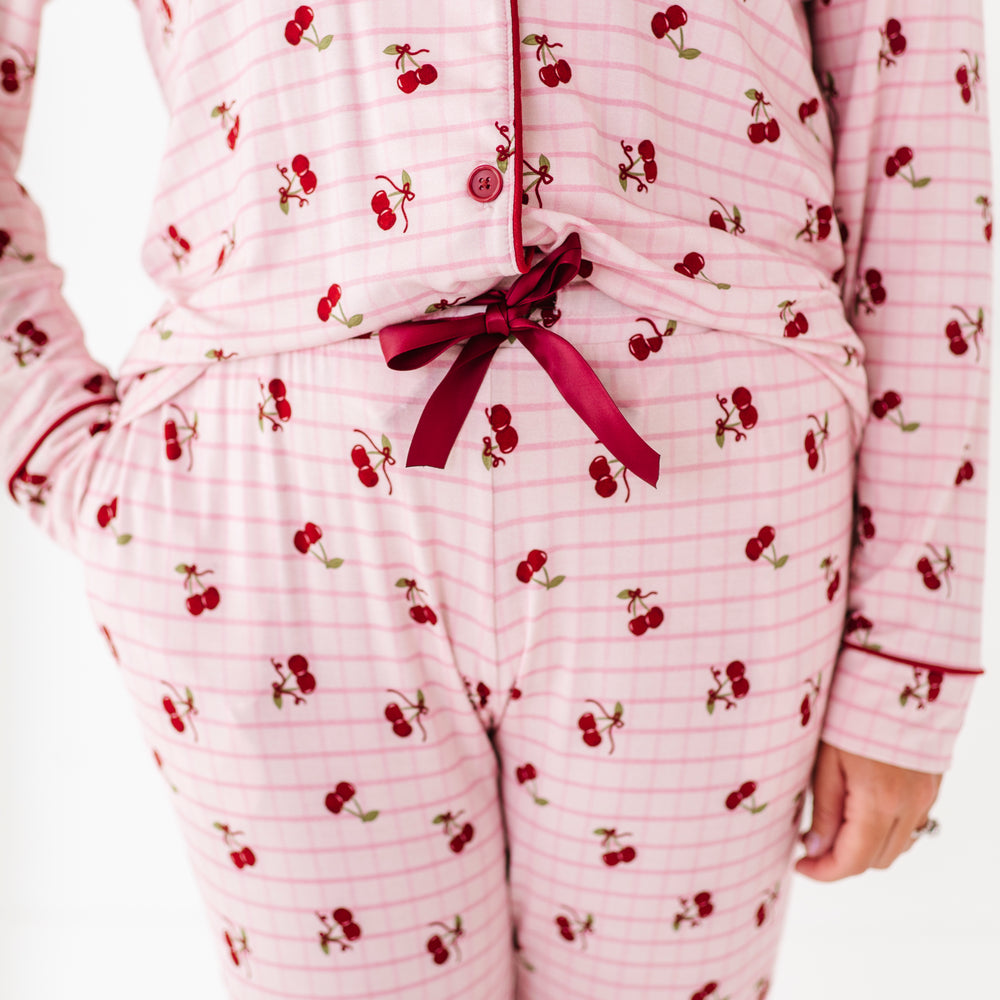 Pink pajama set with cherry pattern on a white background