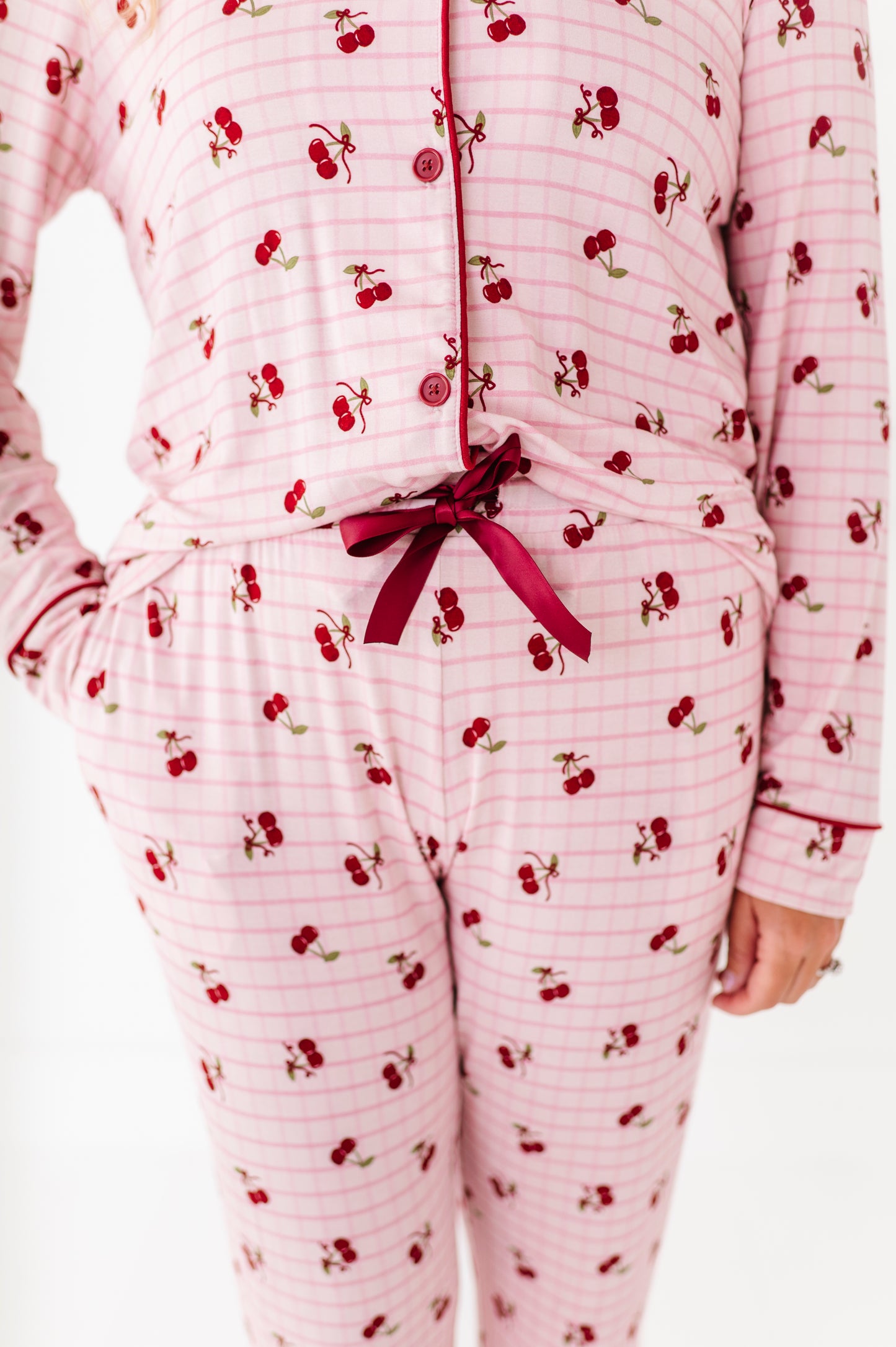 Pink pajama set with cherry pattern on a white background