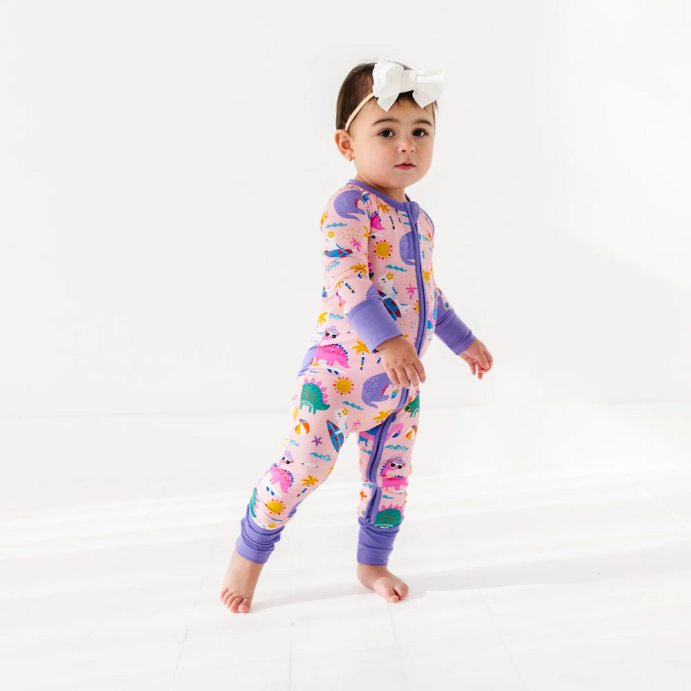 
                      
                        Baby Girl in dinosaur pajamas by Kiki and Lulu
                      
                    