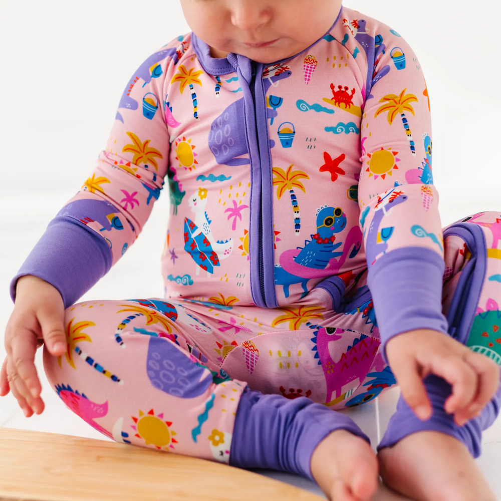 
                      
                        Baby Girl in dinosaur pajamas by Kiki and Lulu
                      
                    