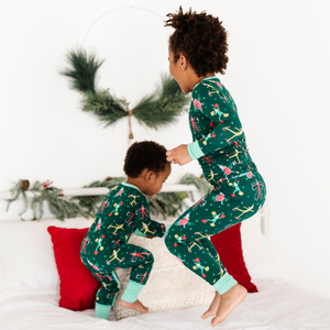 Toddler in elf on the shelf pajamas by Kiki and Lulu