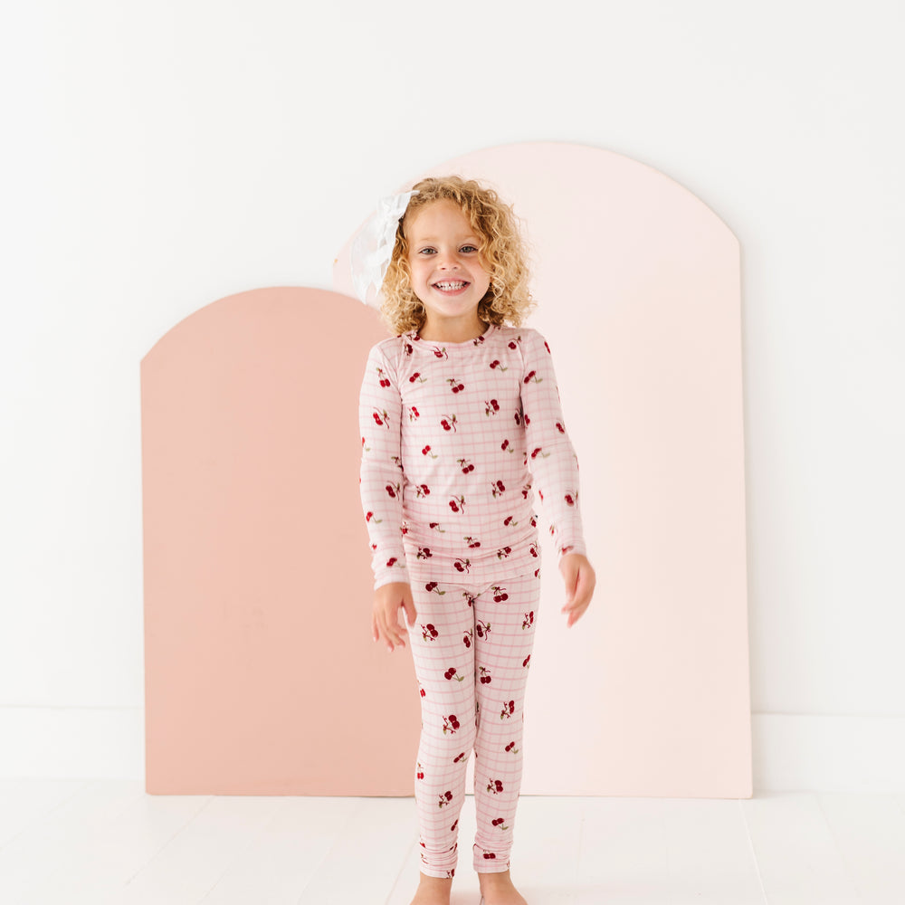 
                      
                        Child wearing a patterned pajama set against a white background
                      
                    