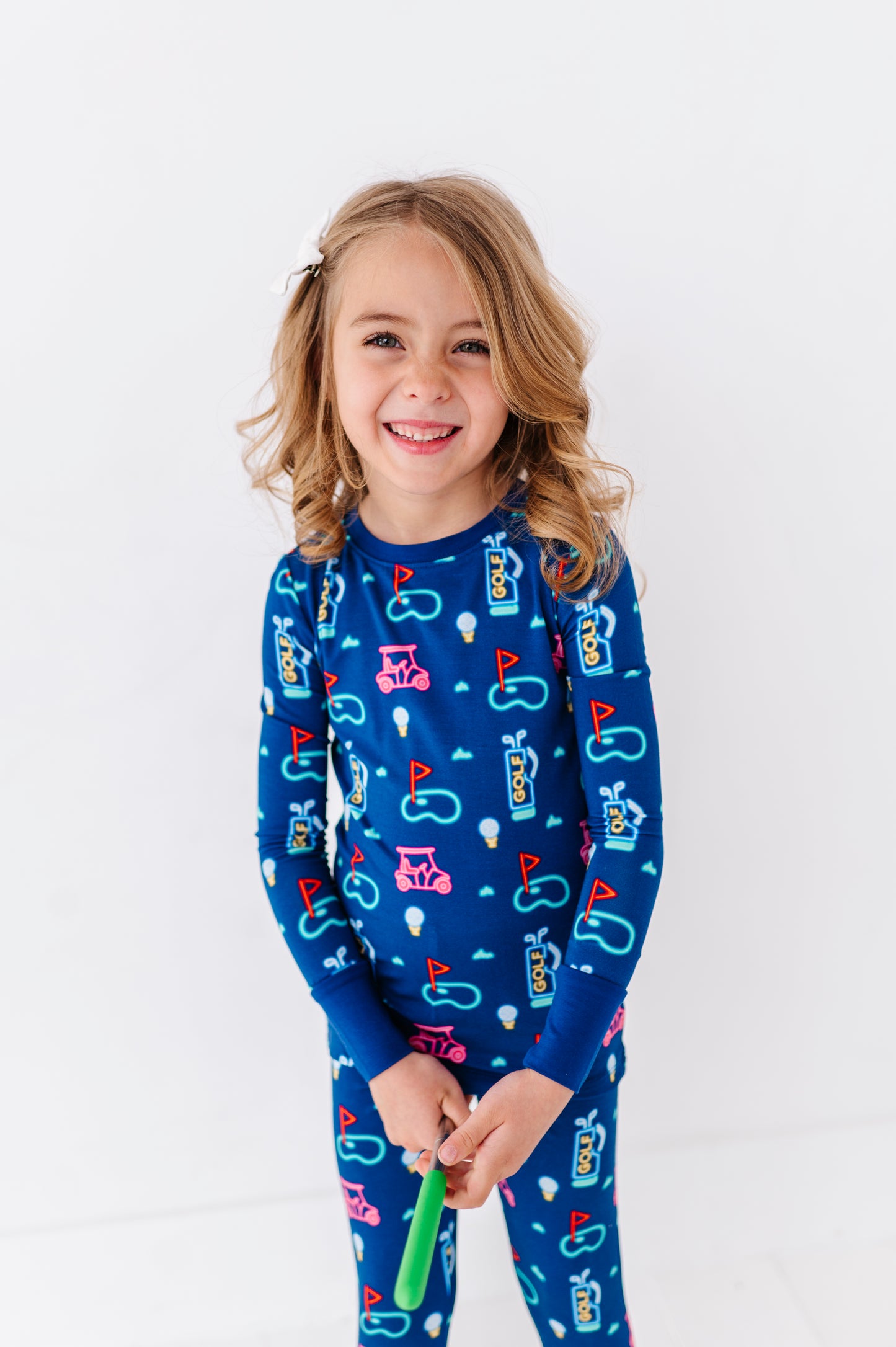 Girl Sporting Neon Golf Pajamas by Kiki and Lulu