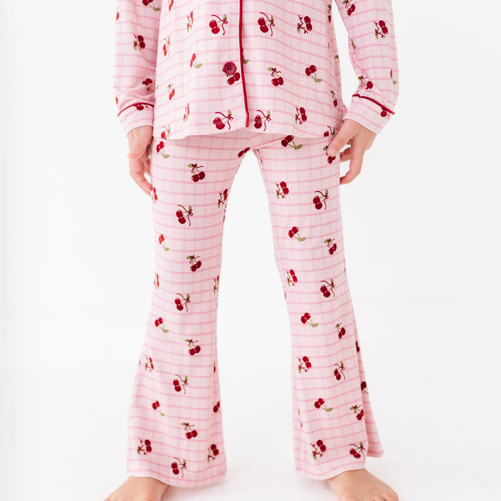 
                      
                        Pink pajama set with cherry pattern on a white background
                      
                    