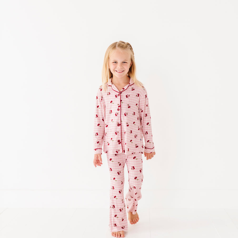 
                      
                        Young girl wearing a pink onesie with a pattern on a white background
                      
                    