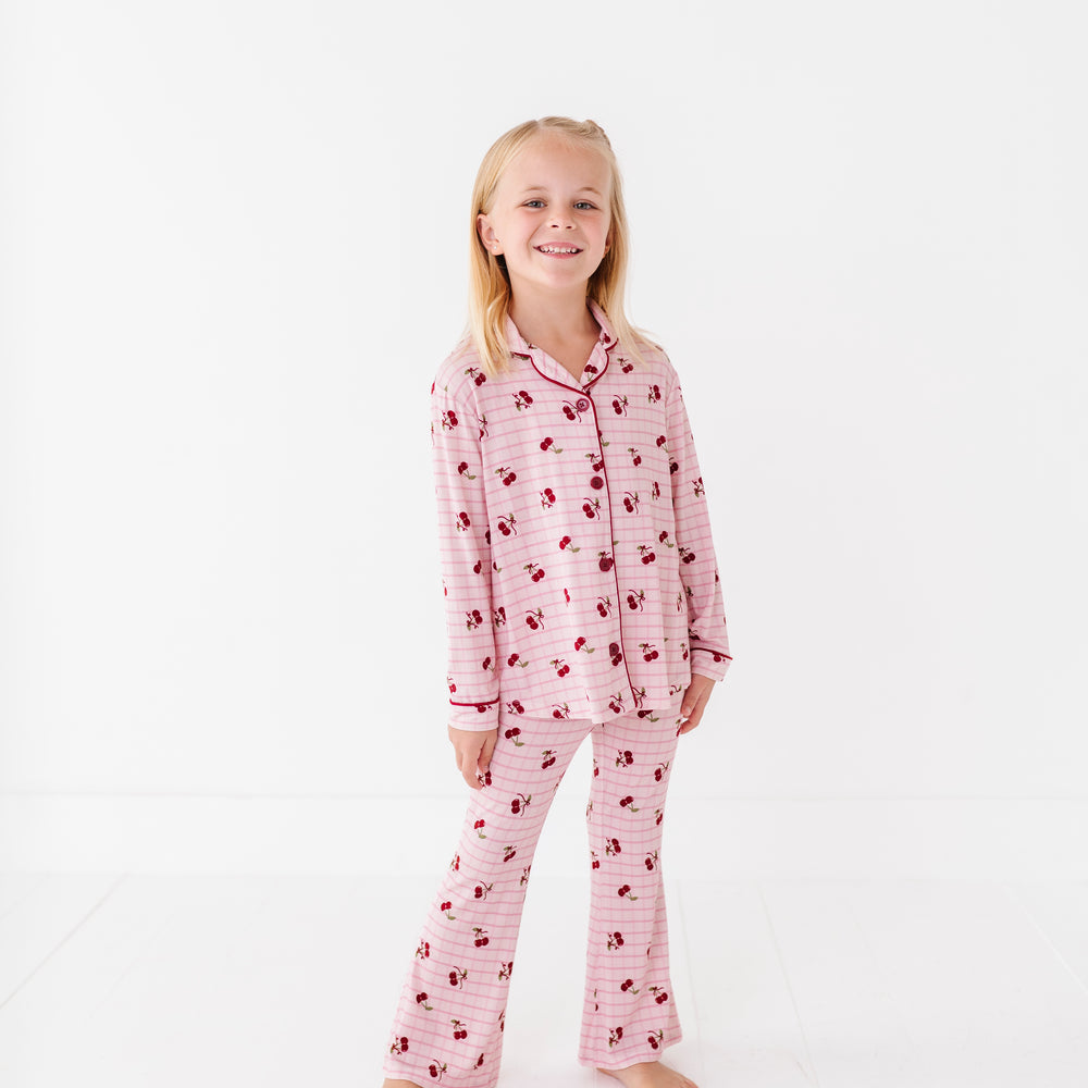 
                      
                        Young girl wearing pink pajamas with a pattern on a white background
                      
                    