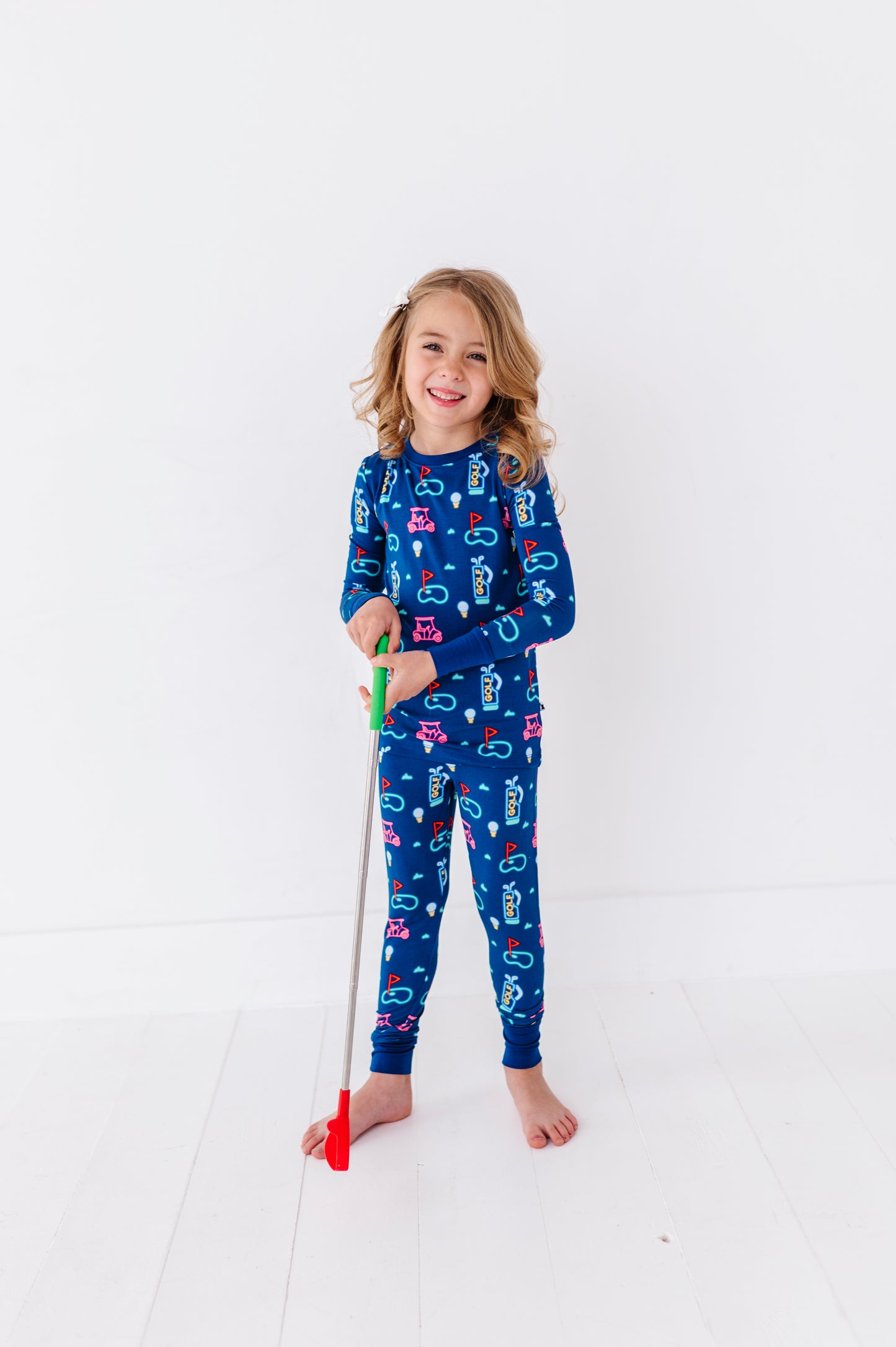 Girl Wearing Neon Golf Pajamas by Kiki and Lulu