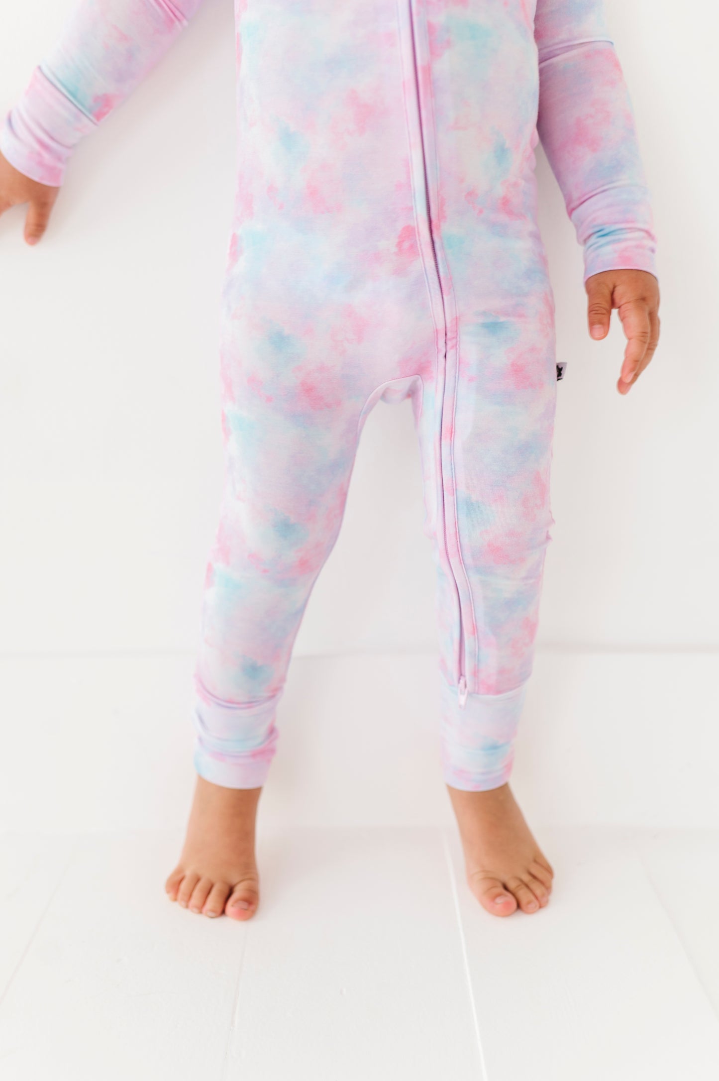 Girl in tie dye convertible footies by Kiki and Lulu