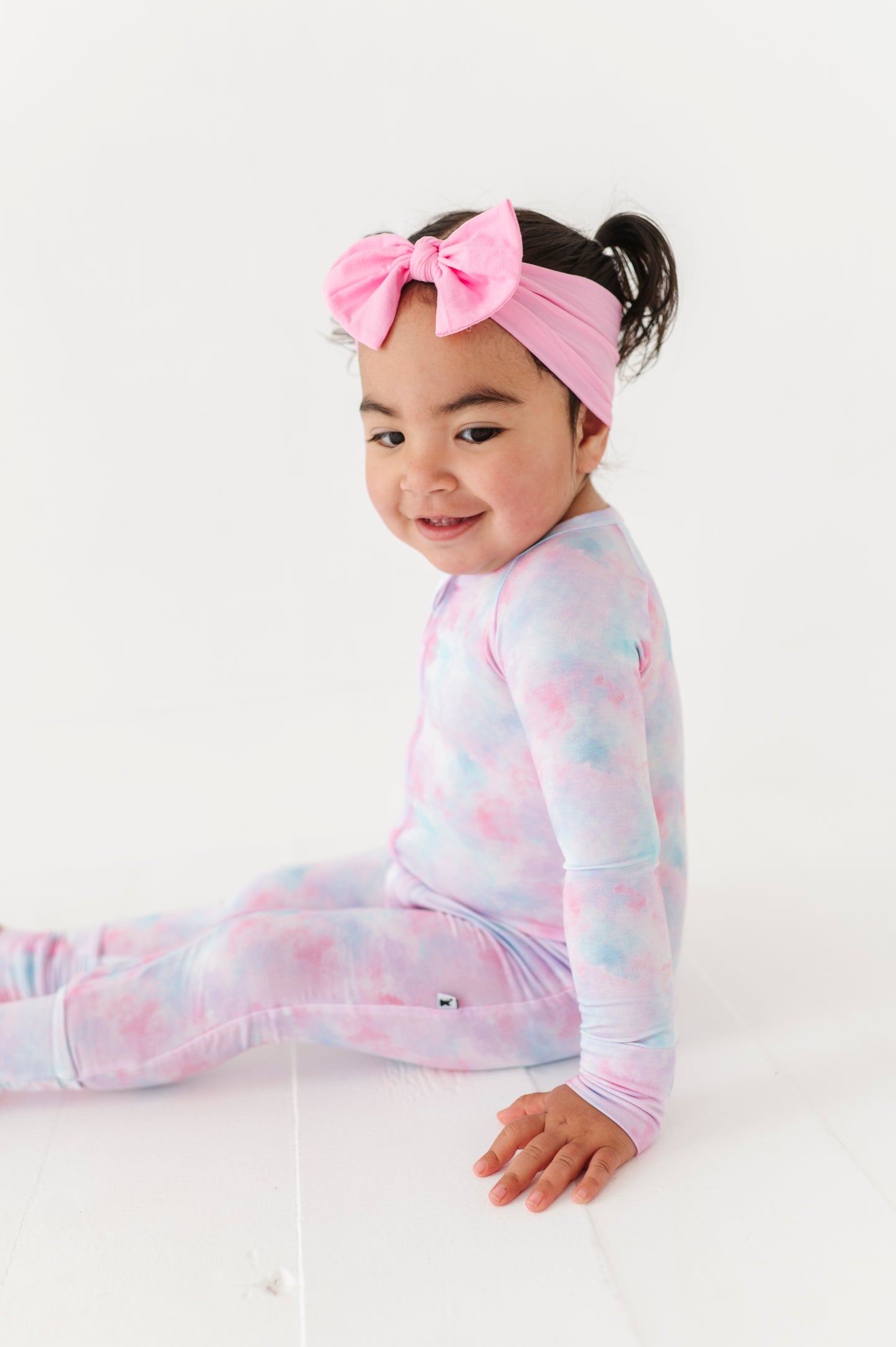 Girl in tie dye convertible footies by Kiki and Lulu