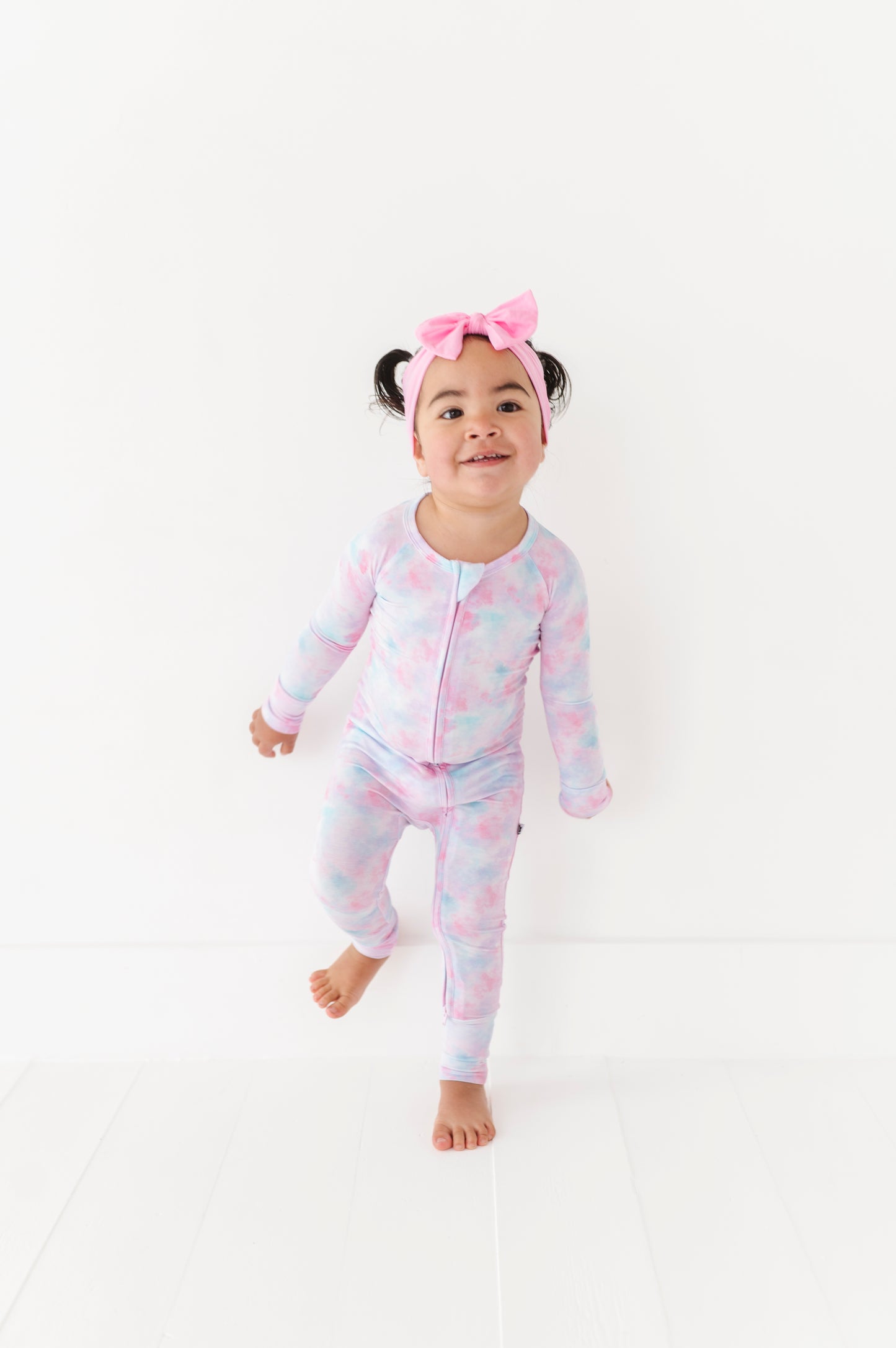 Girl in tie dye convertible footies by Kiki and Lulu