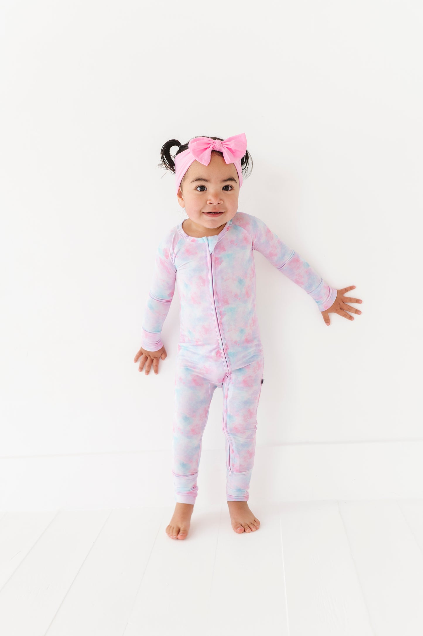 Girl in tie dye convertible footies by Kiki and Lulu