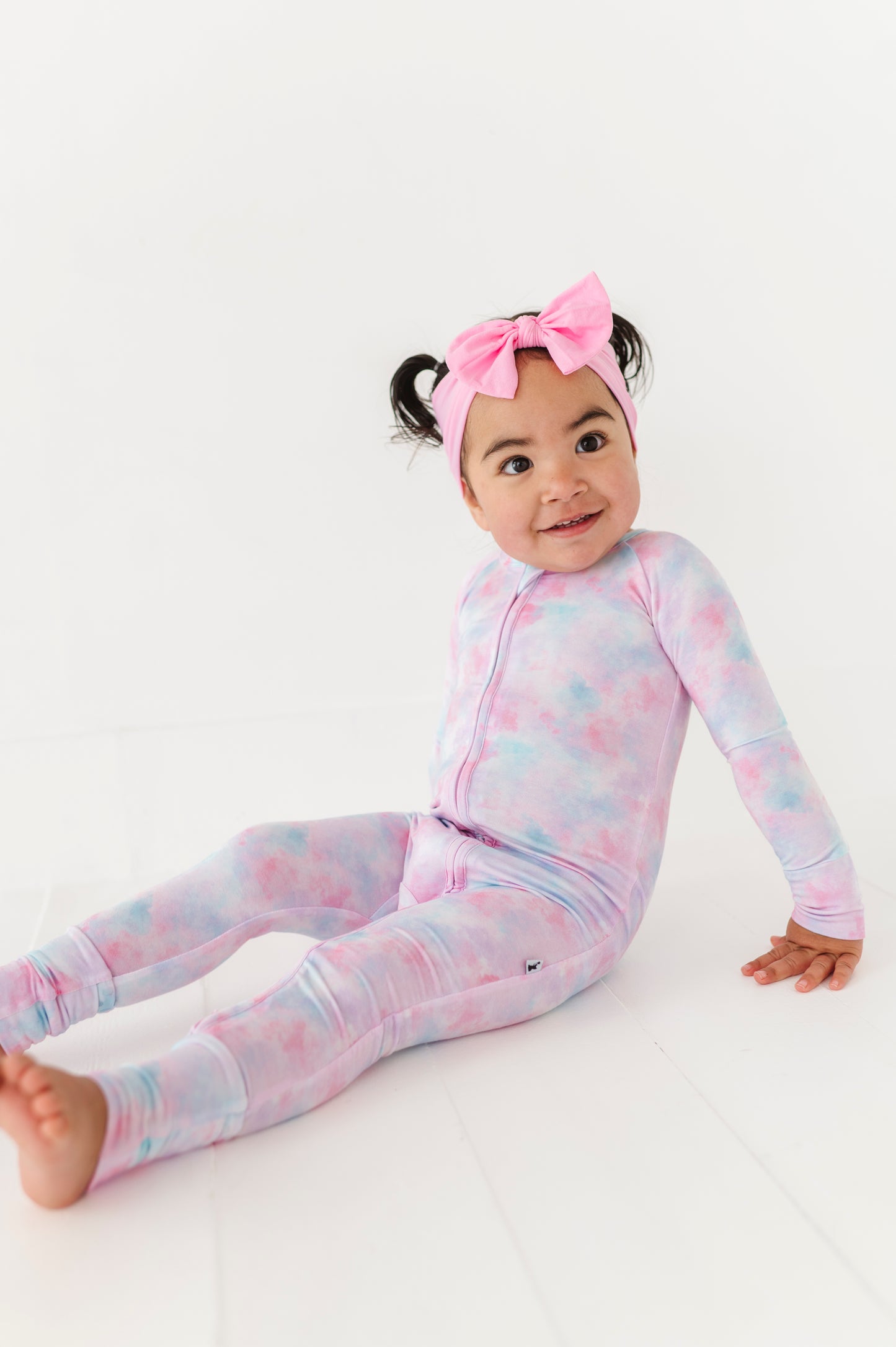 Girl in tie dye convertible footies by Kiki and Lulu