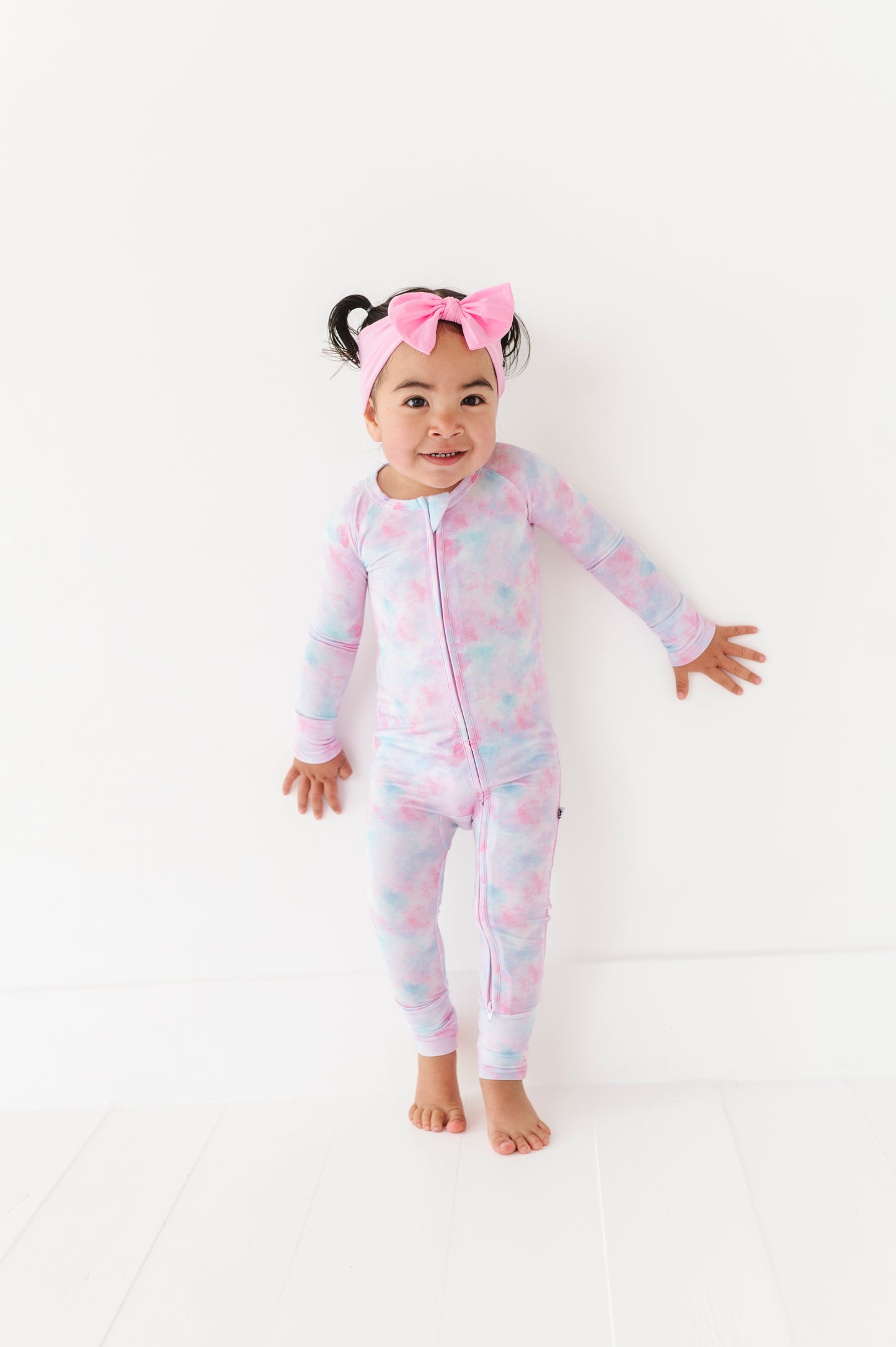 Girl in tie dye convertible footies by Kiki and Lulu