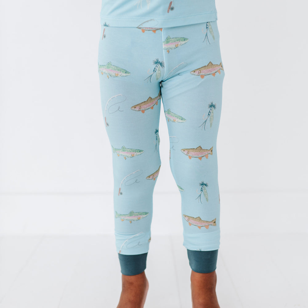 
                      
                        Light blue pajama set with fish pattern on a white background
                      
                    