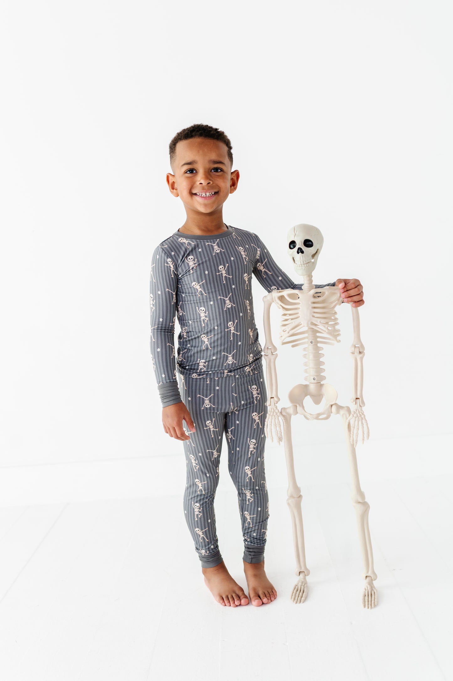Kids Halloween PJs with cute skeletons made for playtime, bedtime, and snuggles