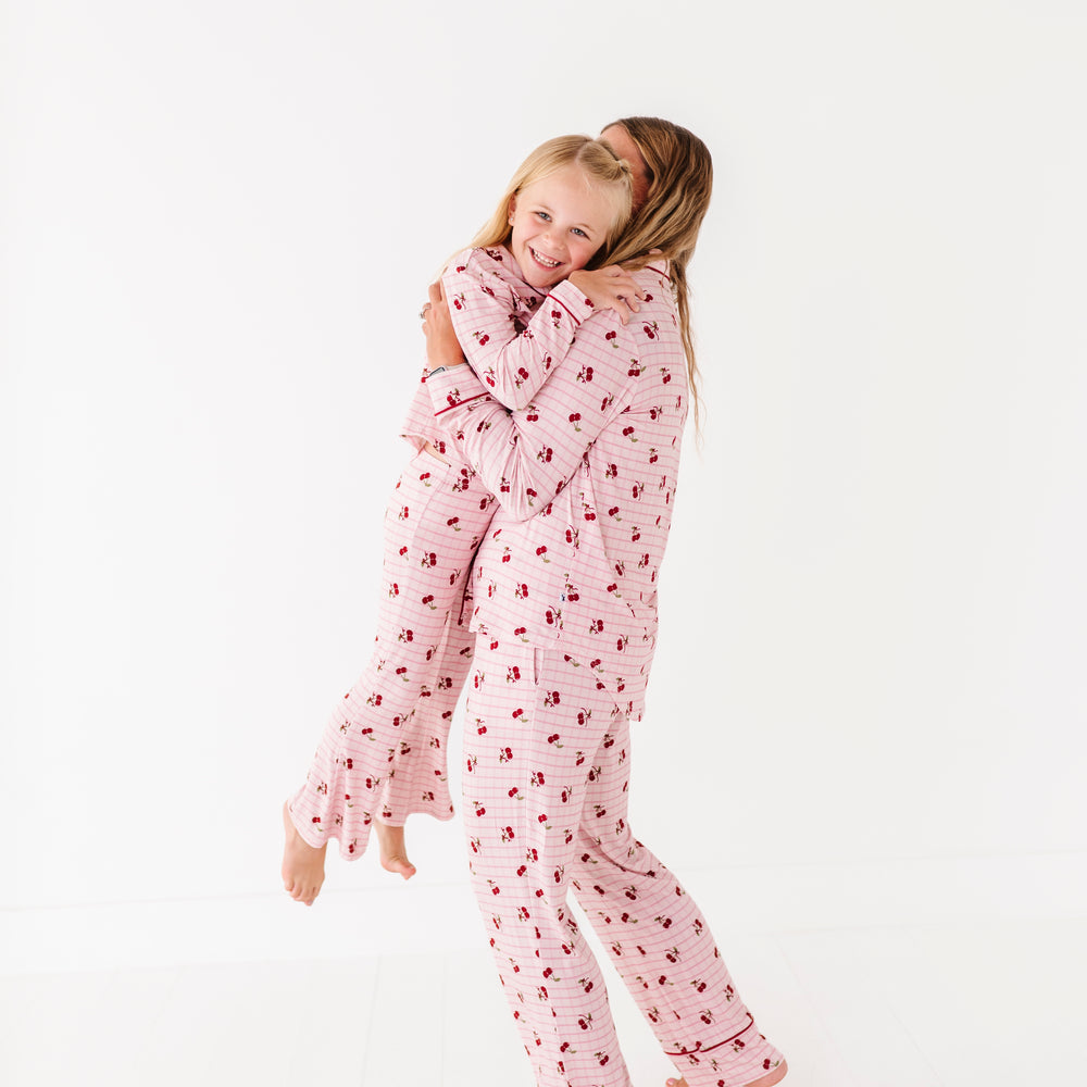 
                      
                        Child wearing pink pajamas with a heart pattern on a white background
                      
                    