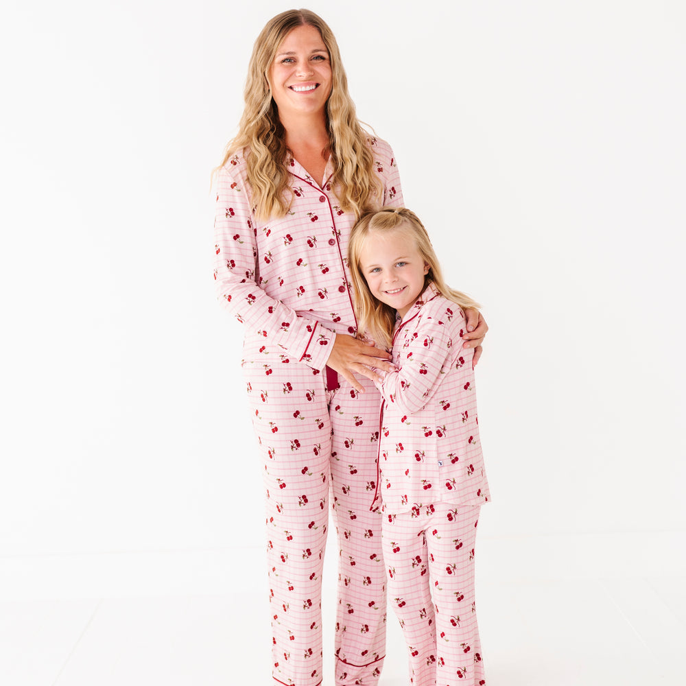 
                      
                        Woman and child wearing matching pink pajamas with red hearts on a white background
                      
                    
