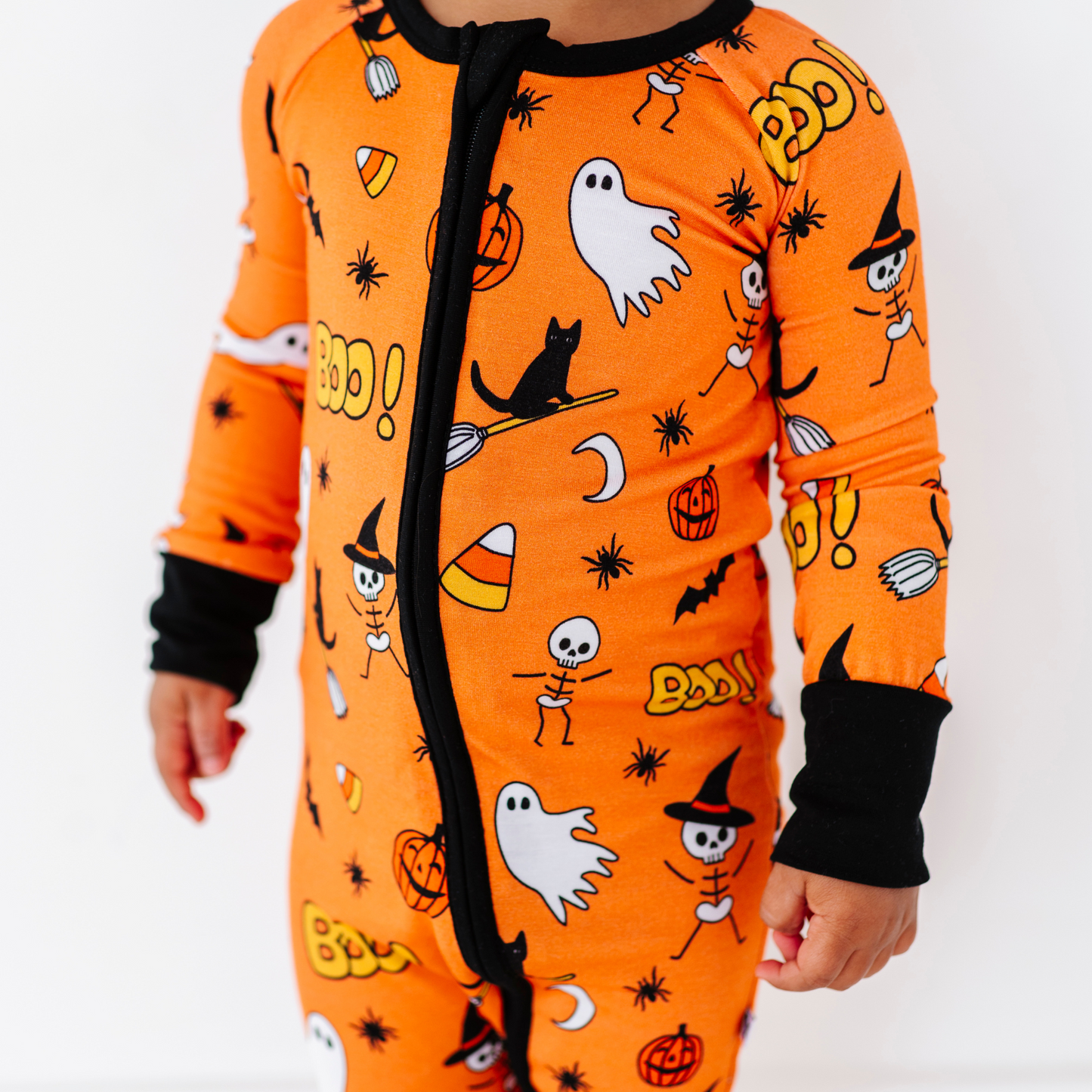 Girl in orange Halloween pajamas by Kiki and Lulu