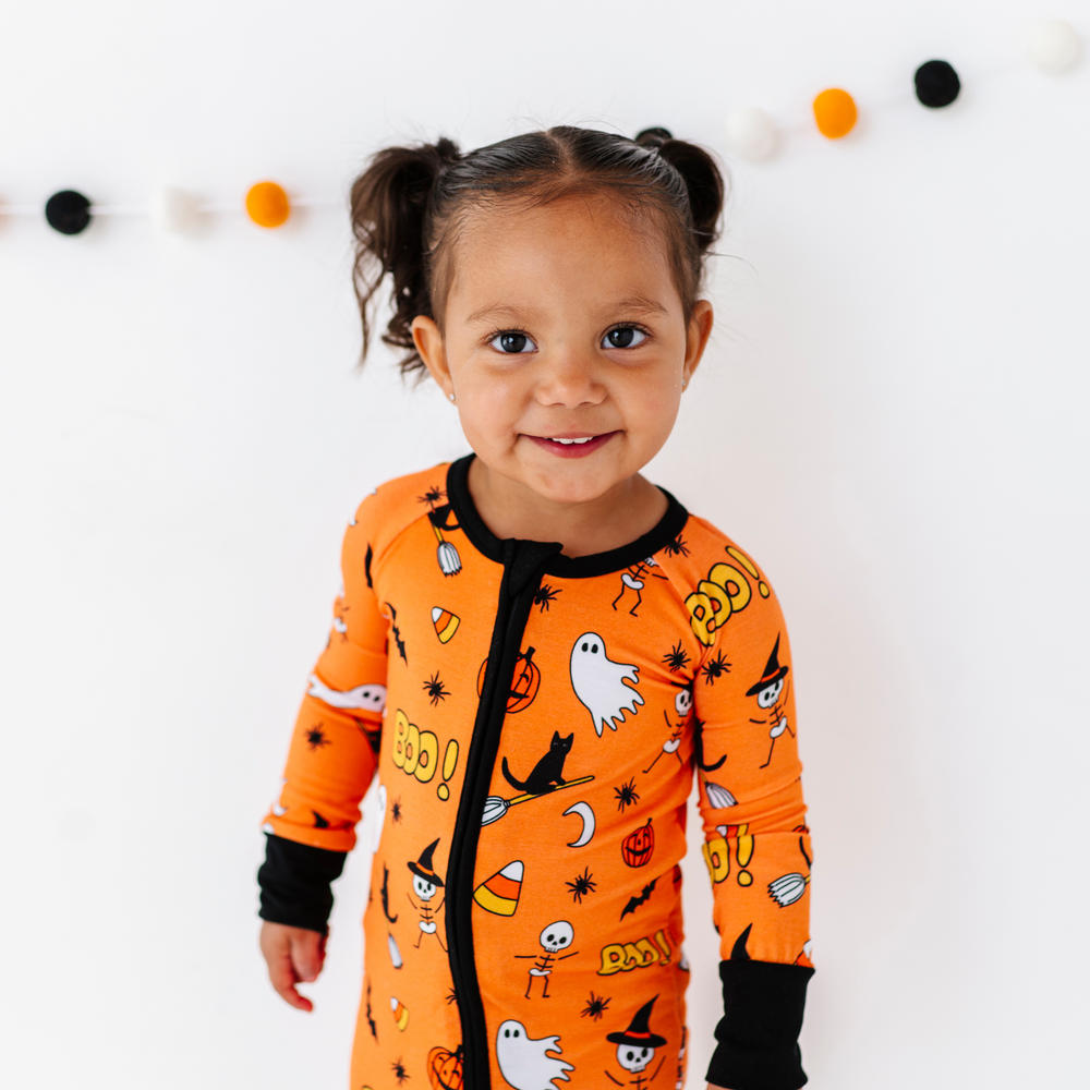 
                      
                        Girl in orange Halloween pajamas by Kiki and Lulu
                      
                    