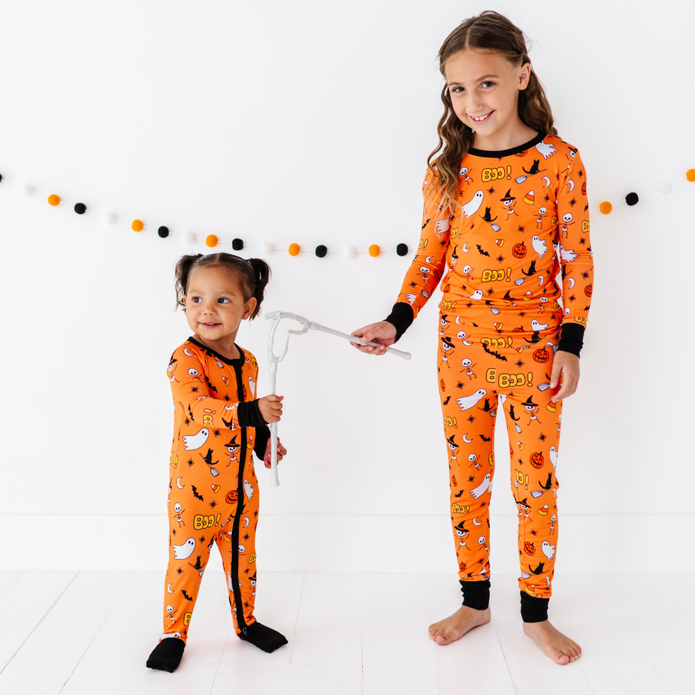 
                      
                        Girl in orange Sibling Matching Halloween pajamas by Kiki and Lulu
                      
                    