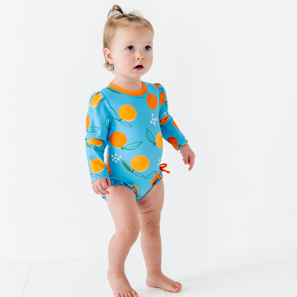 
                      
                        Be My Clementine Long Sleeve Ruffle Swimsuit
                      
                    