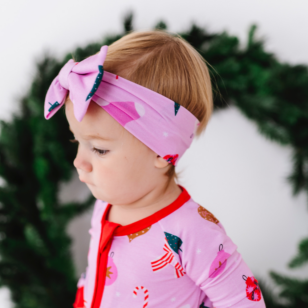 
                      
                        Baby in pink Christmas bow 
                      
                    